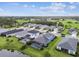 Aerial view of homes with lush landscaping and screened-in backyard pools in a suburban neighborhood at 3326 Woodmont Dr, Parrish, FL 34219