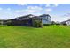 A spacious backyard features a screened-in pool and a well-maintained lawn at 3326 Woodmont Dr, Parrish, FL 34219