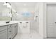 Elegant bathroom featuring marble flooring, grey cabinets, and glass shower at 3326 Woodmont Dr, Parrish, FL 34219