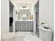 Bright bathroom with white and gray cabinets and a large mirror at 3326 Woodmont Dr, Parrish, FL 34219
