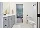 Well-lit bathroom with gray vanity and a view into the adjacent bedroom at 3326 Woodmont Dr, Parrish, FL 34219