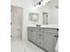 Bathroom showcasing a double sink vanity and marble floors at 3326 Woodmont Dr, Parrish, FL 34219