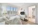 Sun-drenched bedroom features plantation shutters and white furniture with modern decor at 3326 Woodmont Dr, Parrish, FL 34219