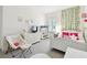 Bright bedroom with carpet, white furniture, TV, string lights, and decorative vines at 3326 Woodmont Dr, Parrish, FL 34219