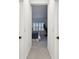 Hallway view of bedroom featuring natural light, carpet, and a treadmill at 3326 Woodmont Dr, Parrish, FL 34219