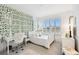 A cozy bedroom with bright natural light has a white bed and a workstation with an accent wall at 3326 Woodmont Dr, Parrish, FL 34219
