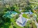 Aerial view showcasing a well-maintained community park featuring a playground, pavilion, and basketball court at 3326 Woodmont Dr, Parrish, FL 34219