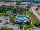 A bird's-eye view of the luxurious pool and clubhouse surrounded by meticulously manicured lawns at 3326 Woodmont Dr, Parrish, FL 34219