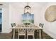 Bright dining room featuring a wooden table set, stylish light fixture, and view of the backyard at 3326 Woodmont Dr, Parrish, FL 34219