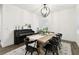 Bright dining room with piano, decorative chandelier, and modern furniture, perfect for entertaining at 3326 Woodmont Dr, Parrish, FL 34219