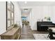 Bright entryway featuring hardwood floors, a piano, and an open floor plan at 3326 Woodmont Dr, Parrish, FL 34219