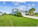 Side view of a charming blue home with a lush green lawn and a two-car garage at 3326 Woodmont Dr, Parrish, FL 34219