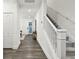 A brightly lit foyer features hardwood floors and a staircase with white railings at 3326 Woodmont Dr, Parrish, FL 34219