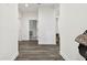 Hallway featuring hardwood floors, white paint, and multiple doors at 3326 Woodmont Dr, Parrish, FL 34219