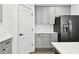 Modern kitchen featuring gray cabinets, white subway tile backsplash, and stainless steel appliances for meal preparation at 3326 Woodmont Dr, Parrish, FL 34219