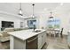 Bright and airy kitchen showcasing an island, stainless steel appliances, and seamless flow to the living space at 3326 Woodmont Dr, Parrish, FL 34219