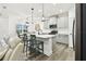 Inviting kitchen featuring a central island, modern appliances, and an adjacent dining area with bright lighting at 3326 Woodmont Dr, Parrish, FL 34219