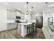 Stylish kitchen boasts sleek gray cabinets, stainless steel appliances, and a quartz countertop island at 3326 Woodmont Dr, Parrish, FL 34219