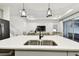 A well-appointed kitchen island features a modern faucet and offers views of the staircase and living room at 3326 Woodmont Dr, Parrish, FL 34219