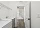 Hallway view into laundry room with washer, dryer, sink, and shelving at 3326 Woodmont Dr, Parrish, FL 34219