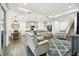 Open-concept living room featuring a modern kitchen, dining area, and comfortable seating arrangement at 3326 Woodmont Dr, Parrish, FL 34219