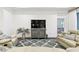 Comfortable living room featuring a TV and access to another room and view of a bed at 3326 Woodmont Dr, Parrish, FL 34219