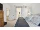 Open Primary bedroom with ensuite bath access through sliding barn door at 3326 Woodmont Dr, Parrish, FL 34219