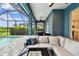 Relaxing outdoor space with a pool, fire table, and barbecue setup at 3326 Woodmont Dr, Parrish, FL 34219