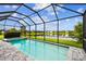 Screened-in pool and hot tub overlooking a serene lake and green backyard at 3326 Woodmont Dr, Parrish, FL 34219