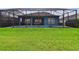 A relaxing backyard pool is surrounded by a screen enclosure and lush green grass at 3326 Woodmont Dr, Parrish, FL 34219
