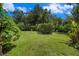 Spacious backyard with lush green lawn and privacy landscaping at 3335 Foxridge Cir, Tampa, FL 33618