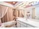 Clean bathroom with a mirrored vanity, tub/shower combo and neutral decor at 3335 Foxridge Cir, Tampa, FL 33618