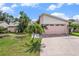 Home featuring a pink garage door and tropical landscaping at 3335 Foxridge Cir, Tampa, FL 33618