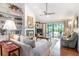 Cozy living room with built-in shelves, a fireplace, and access to the outdoors at 3335 Foxridge Cir, Tampa, FL 33618