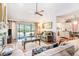 Open living room with a fireplace and sliding glass doors to the patio at 3335 Foxridge Cir, Tampa, FL 33618