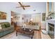 Cozy living room featuring a fireplace and a ceiling fan at 3335 Foxridge Cir, Tampa, FL 33618