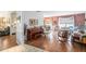 Open living room features a piano and a cozy seating area with wood floors at 3335 Foxridge Cir, Tampa, FL 33618