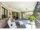 Relaxing screened porch with comfortable seating and view of the outdoors at 3335 Foxridge Cir, Tampa, FL 33618