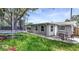 Cozy backyard with a small patio, a trampoline, and a well-maintained lawn, perfect for outdoor entertaining at 3426 Coldwell Dr, Holiday, FL 34691