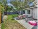Charming backyard with a patio dining set, trampoline, and lush greenery, ideal for relaxation and play at 3426 Coldwell Dr, Holiday, FL 34691