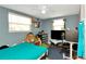 This bedroom offers ample natural light from two windows and blue painted walls at 3426 Coldwell Dr, Holiday, FL 34691