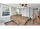 Bedroom with a large bed, windows, ceiling fan, and hard wood floors at 3426 Coldwell Dr, Holiday, FL 34691