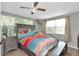 Bright bedroom with a large bed, a ceiling fan, and multiple windows for natural light at 3426 Coldwell Dr, Holiday, FL 34691