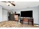 This bedroom features a ceiling fan and a desk with a large monitor setup at 3426 Coldwell Dr, Holiday, FL 34691