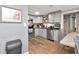 Modern kitchen featuring grey cabinets, stainless steel appliances, and hard wood flooring at 3426 Coldwell Dr, Holiday, FL 34691