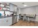 Bright kitchen and dining area featuring grey cabinets, modern appliances, and wood floors at 3426 Coldwell Dr, Holiday, FL 34691