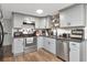 Galley kitchen with grey cabinets, stainless steel appliances, and hard wood flooring at 3426 Coldwell Dr, Holiday, FL 34691