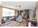 Cozy living room area with a large sectional couch, wood floors, and neutral decor at 3426 Coldwell Dr, Holiday, FL 34691