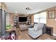 Spacious living room featuring wood floors, large sectional couch, and a tv with built-ins at 3426 Coldwell Dr, Holiday, FL 34691