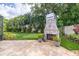 Well maintained backyard featuring an outdoor fireplace, brick patio, putting green, and lush landscaping for the Gathering at 3437 Aspen Trl, Clearwater, FL 33761